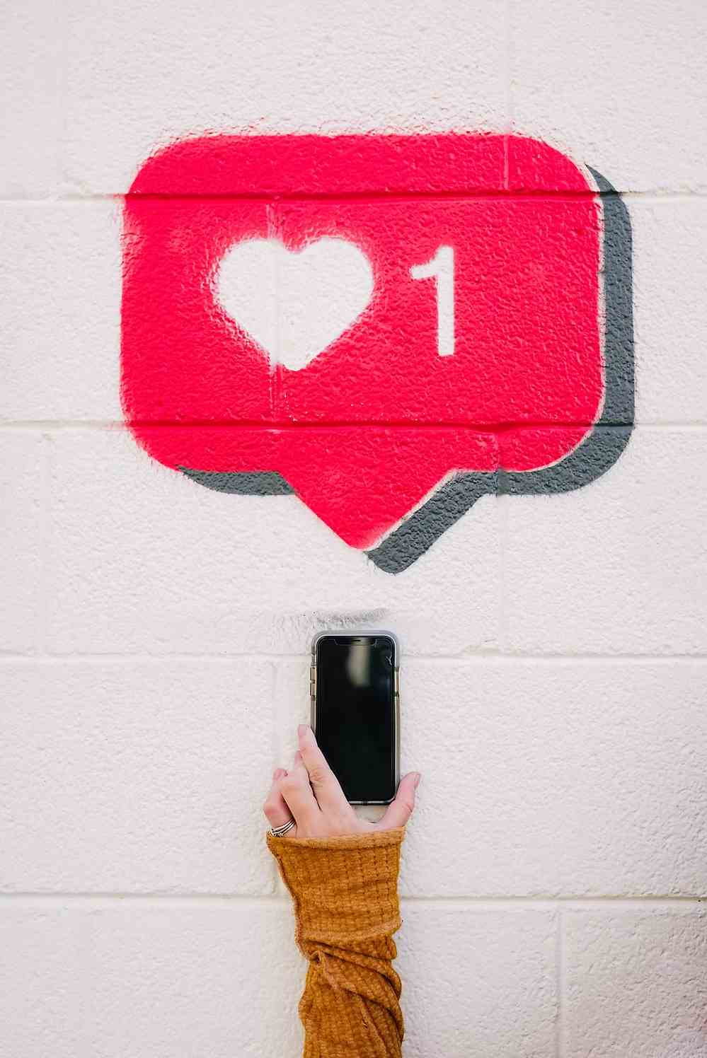 Smartphone screen displaying Instagram post insights with metrics for reach, impressions, and engagement.