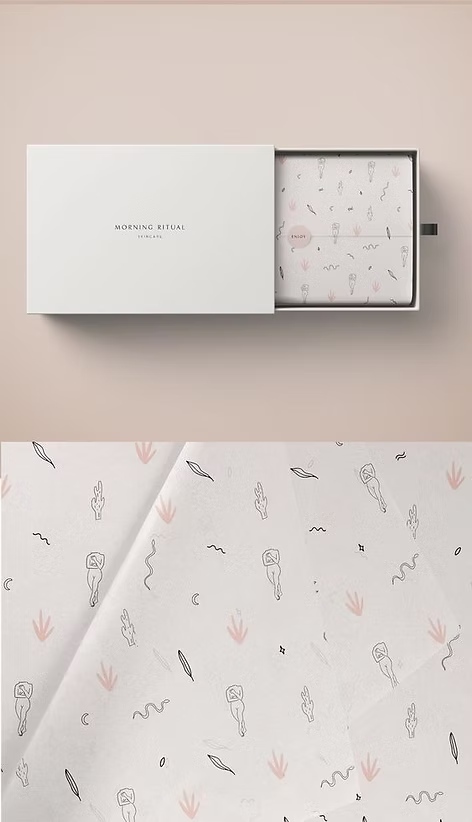 White gift box packaging with minimalist design containing patterned tissue paper with small illustrated motifs.